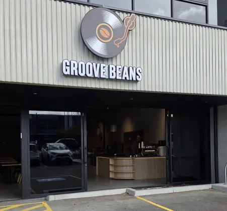 Groove Beans shopfront by day with the record-logo sign and glass doors